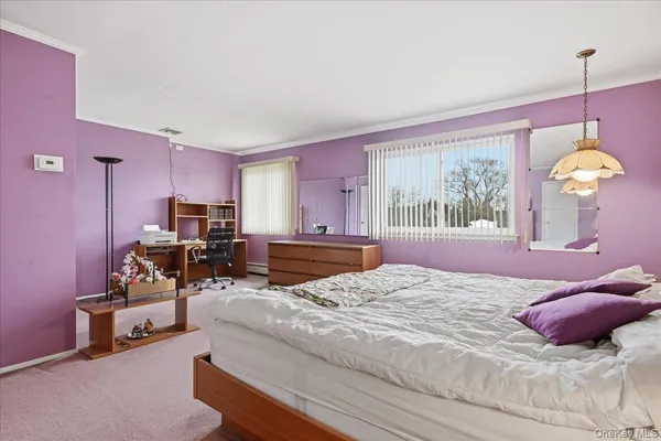 a bedroom with bed and window