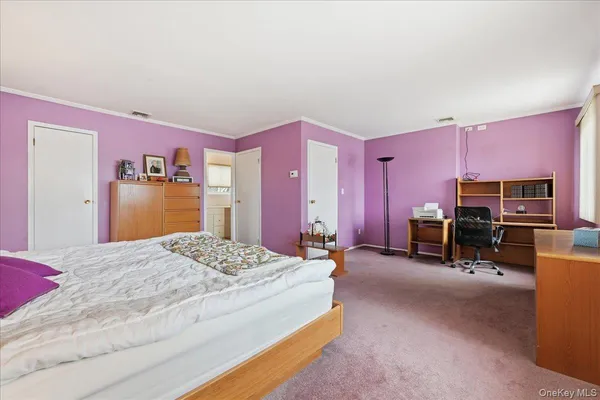 a spacious bedroom with a bed and a couch