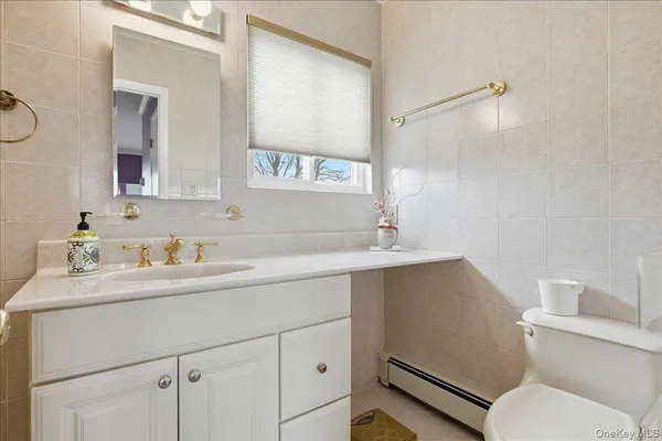 a bathroom with a sink toilet and mirror
