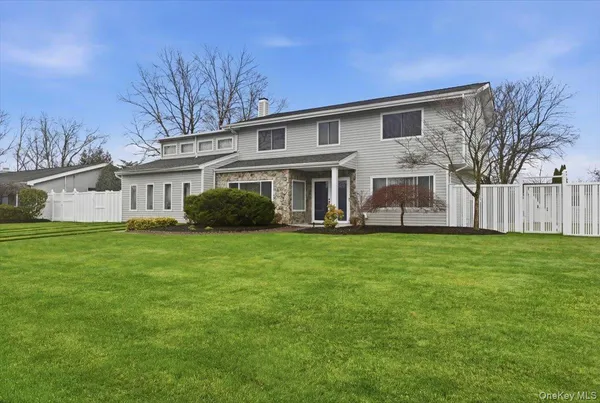 a front view of house with yard and green space