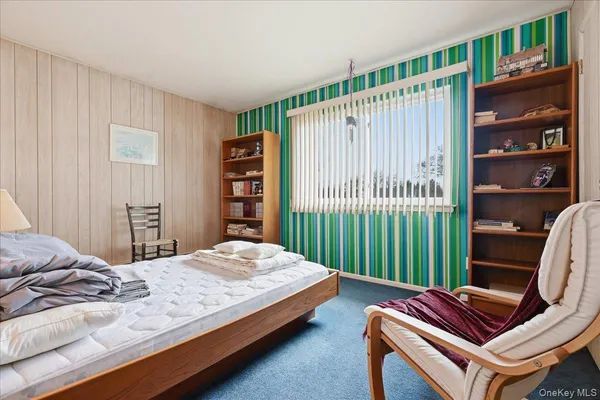a bedroom with a bed and a book shelf