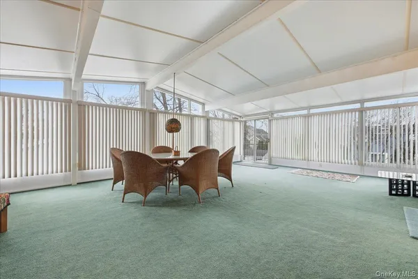 a view of a room with furniture and a window