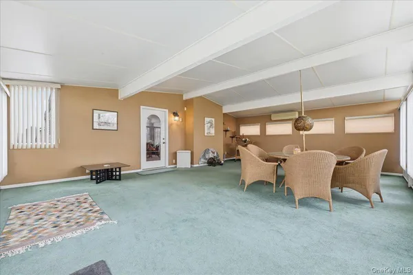 a dining room with furniture and a window