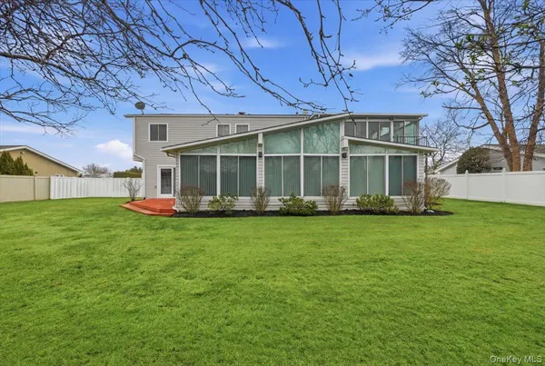 a front view of a house with a garden and yard