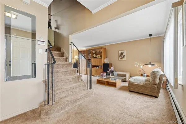 a living room with furniture and a floor to ceiling window