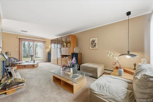 a living room with furniture a large window and gym equipment