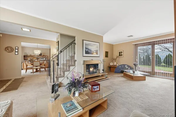a living room with furniture a fireplace and a large window