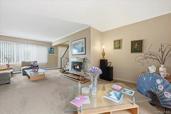 a living room with furniture a fireplace and a window