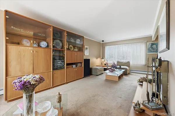 a living room with furniture and flowers