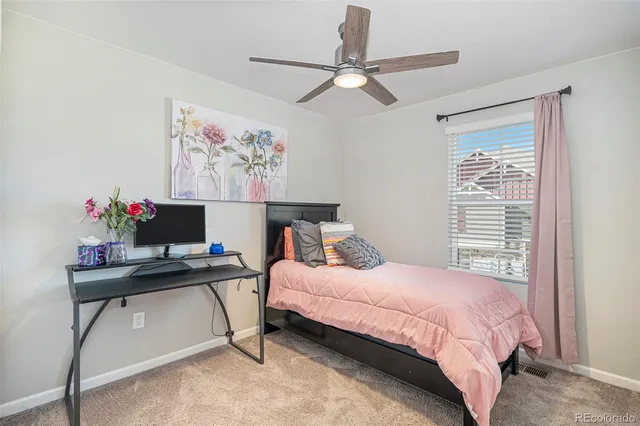 a bedroom with a bed table and a window
