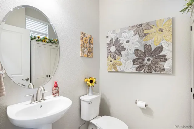 a bathroom with a sink mirror and toilet