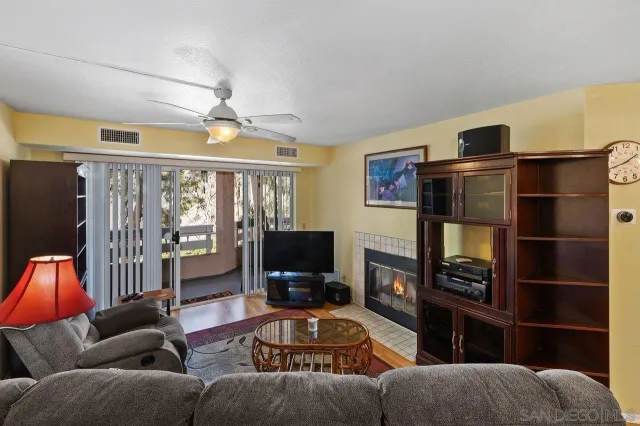a living room with furniture and a ceiling fan