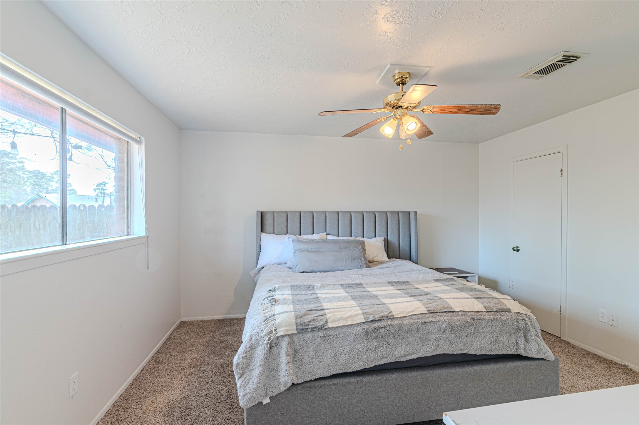 4606 Fitzwater Drive Spring, TX 77373 - Photo 26 of 42 a bedroom with a bed and a chandelier fan