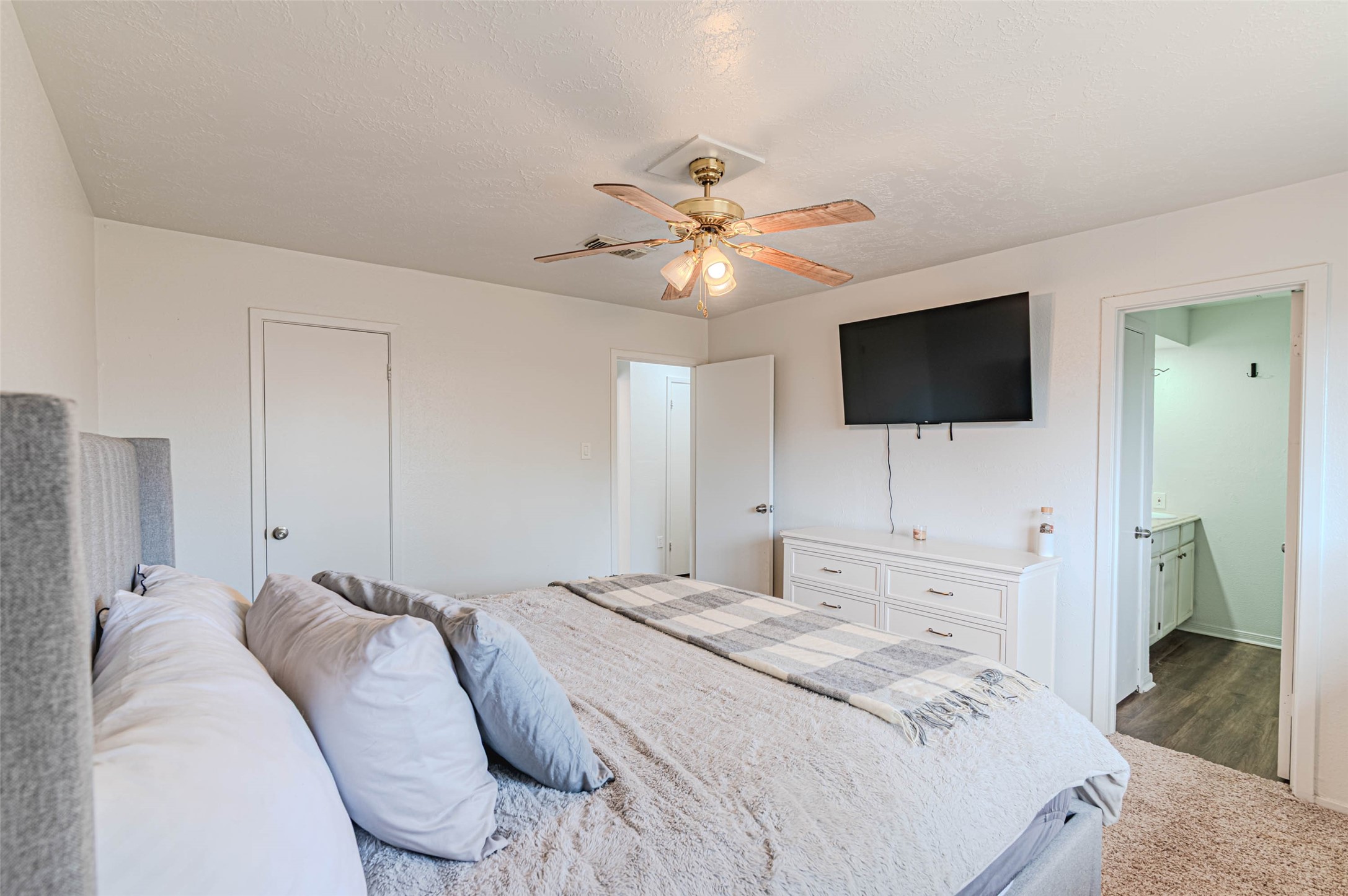 4606 Fitzwater Drive Spring, TX 77373 - Photo 29 of 42 a bedroom with a bed a flat tv screen and a chandelier