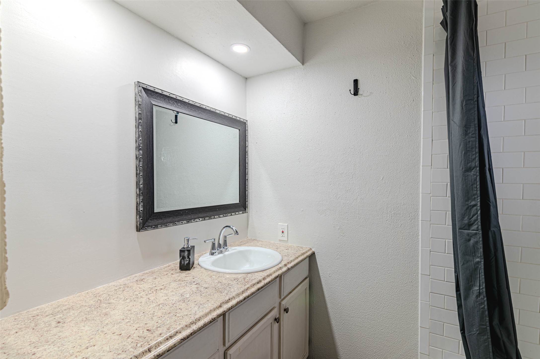 4606 Fitzwater Drive Spring, TX 77373 - Photo 30 of 42 a bathroom with a granite countertop sink and a mirror