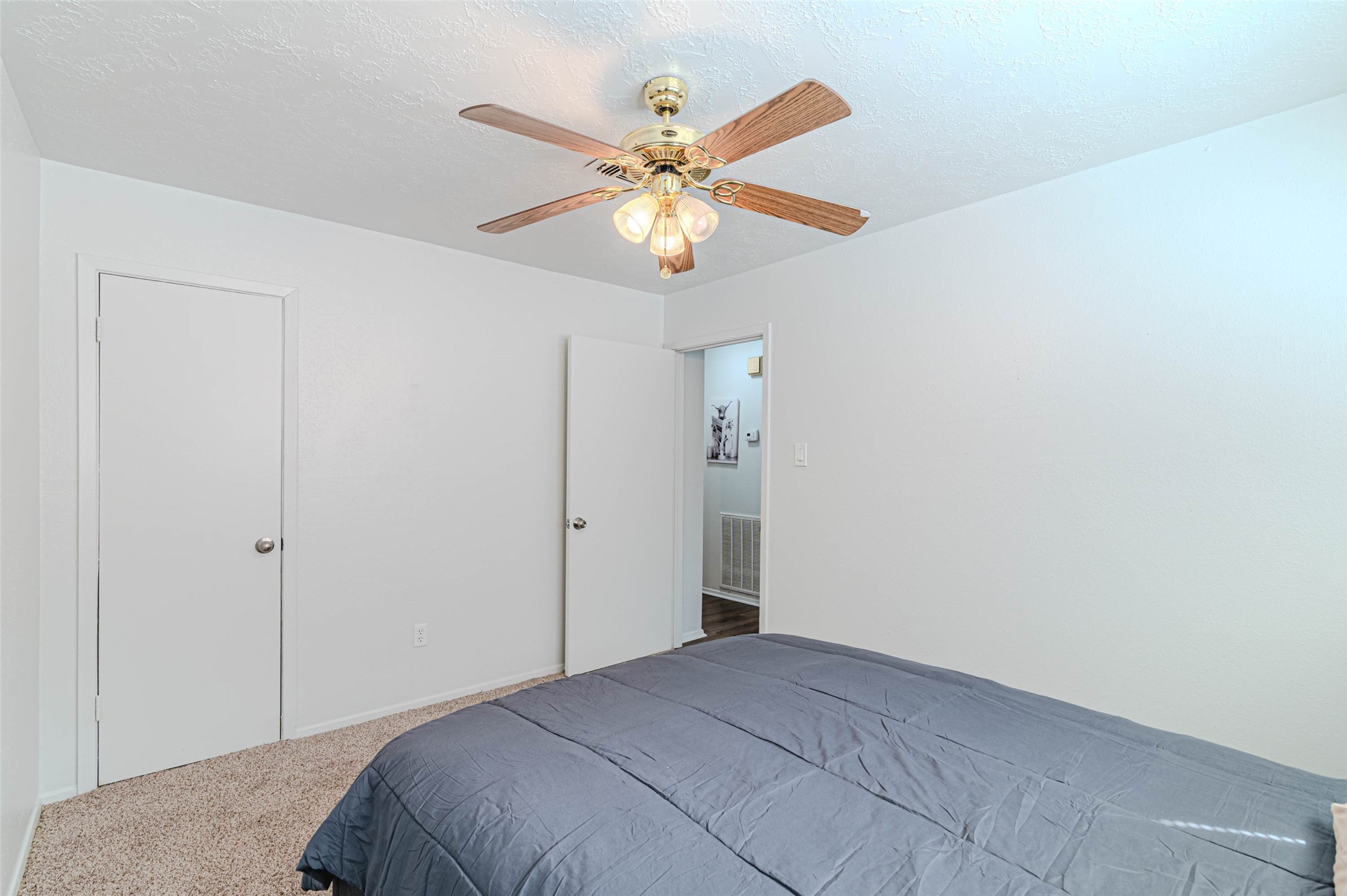 4606 Fitzwater Drive Spring, TX 77373 - Photo 35 of 42 a bedroom with a bed and a chandelier