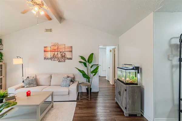 a living room with furniture and a potted plant