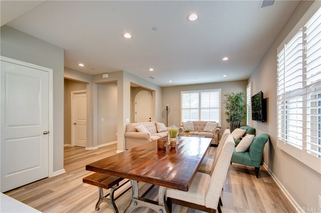 168 Outwest Irvine, CA 92618 - Photo 12 of 36 a view of a dining room with furniture window and wooden floor
