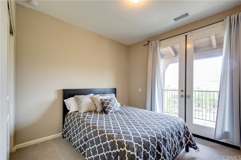 168 Outwest Irvine, CA 92618 - Photo 23 of 36 a bedroom with a large bed and a large window