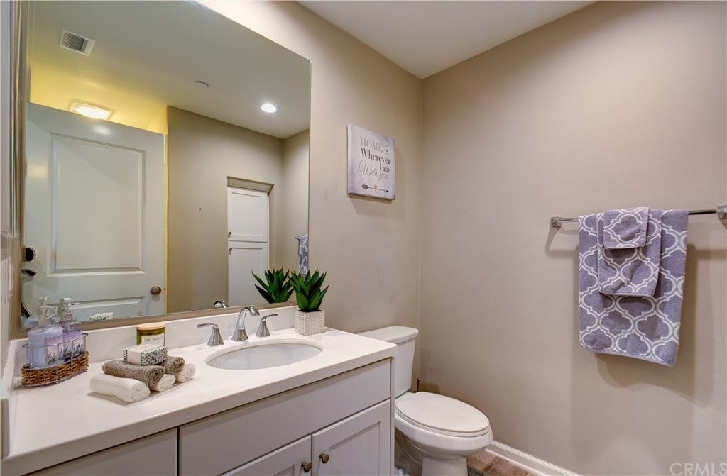 168 Outwest Irvine, CA 92618 - Photo 24 of 36 a bathroom with a granite countertop sink mirror and toilet