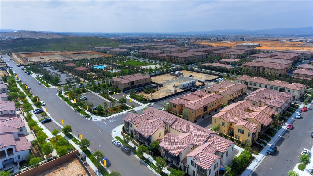 168 Outwest Irvine, CA 92618 - Photo 34 of 36 an aerial view of a city with lots of residential buildings and mountain view in back