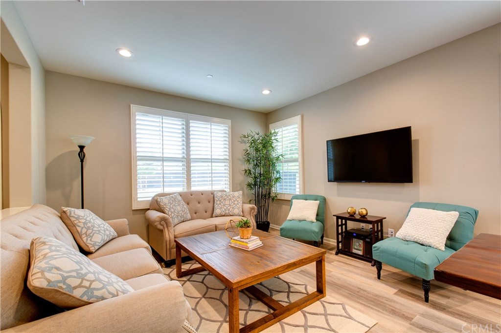 168 Outwest Irvine, CA 92618 - Photo 6 of 36 a living room with furniture and a flat screen tv