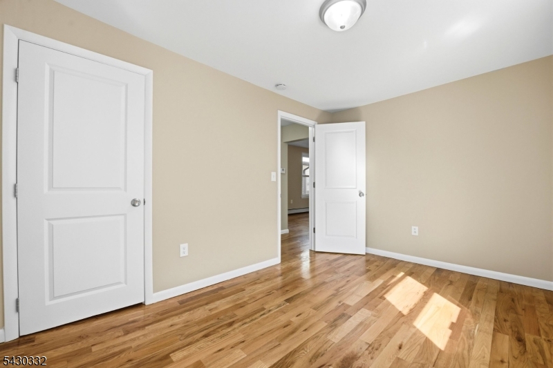 164 South Ridgewood Road South Orange, NJ 07079 - Photo 14 of 20 a view of an empty room with wooden floor and closet