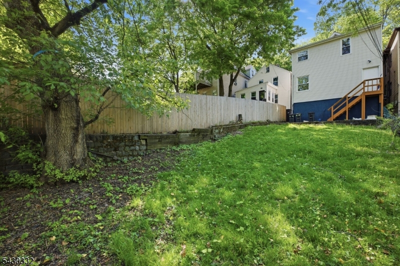 164 South Ridgewood Road South Orange, NJ 07079 - Photo 20 of 20 a view of a backyard with plants and a large tree