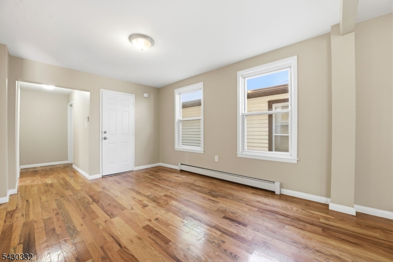 164 South Ridgewood Road South Orange, NJ 07079 - Photo 3 of 20 a view of an empty room with wooden floor and a window