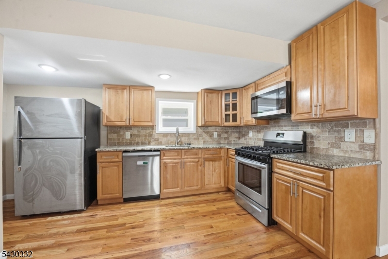 164 South Ridgewood Road South Orange, NJ 07079 - Photo 5 of 20 a kitchen with granite countertop a refrigerator stove top oven and sink