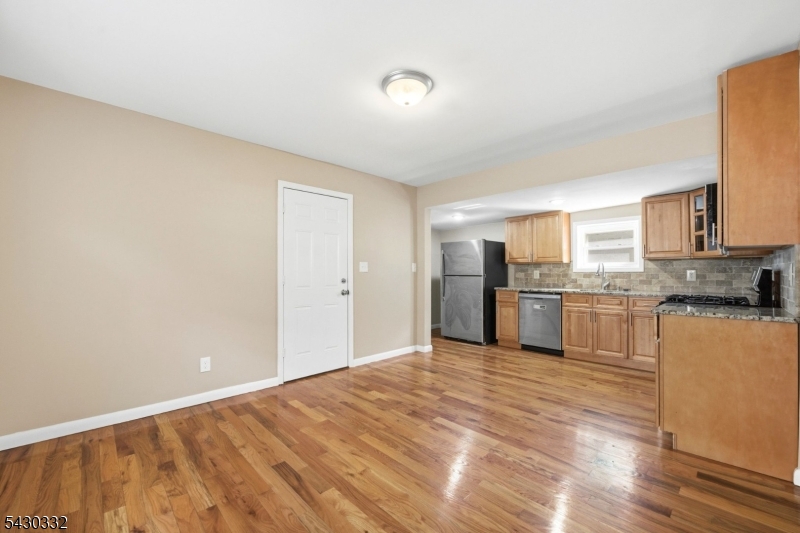 164 South Ridgewood Road South Orange, NJ 07079 - Photo 8 of 20 a view of a kitchen with a sink and dishwasher a refrigerator with wooden floor