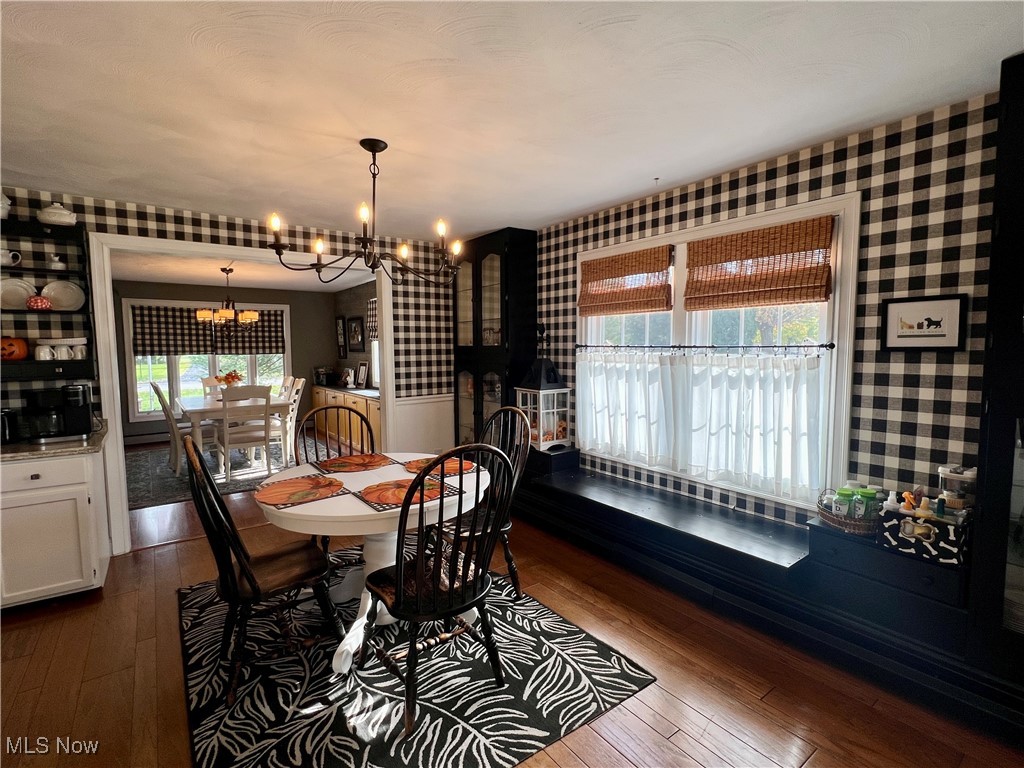 446 Annis Road Amherst, OH 44001 - Photo 8 of 39 Dining area with a chandelier and dark hardwood / wood-style flooring