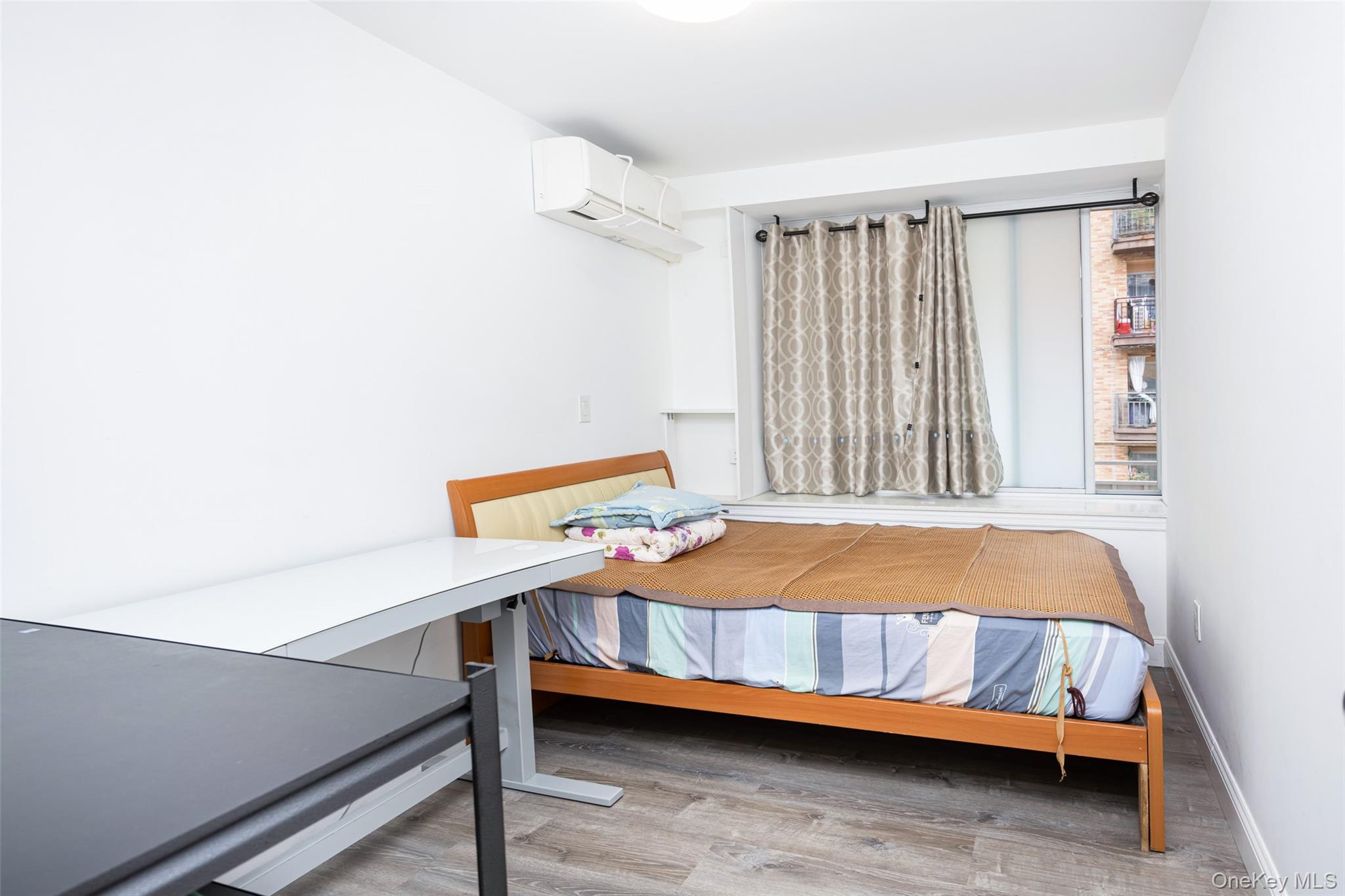 43-17 Union Street, Unit 4E Queens, NY 11355 - Photo 5 of 19 Bedroom with light wood-type flooring and an AC wall unit