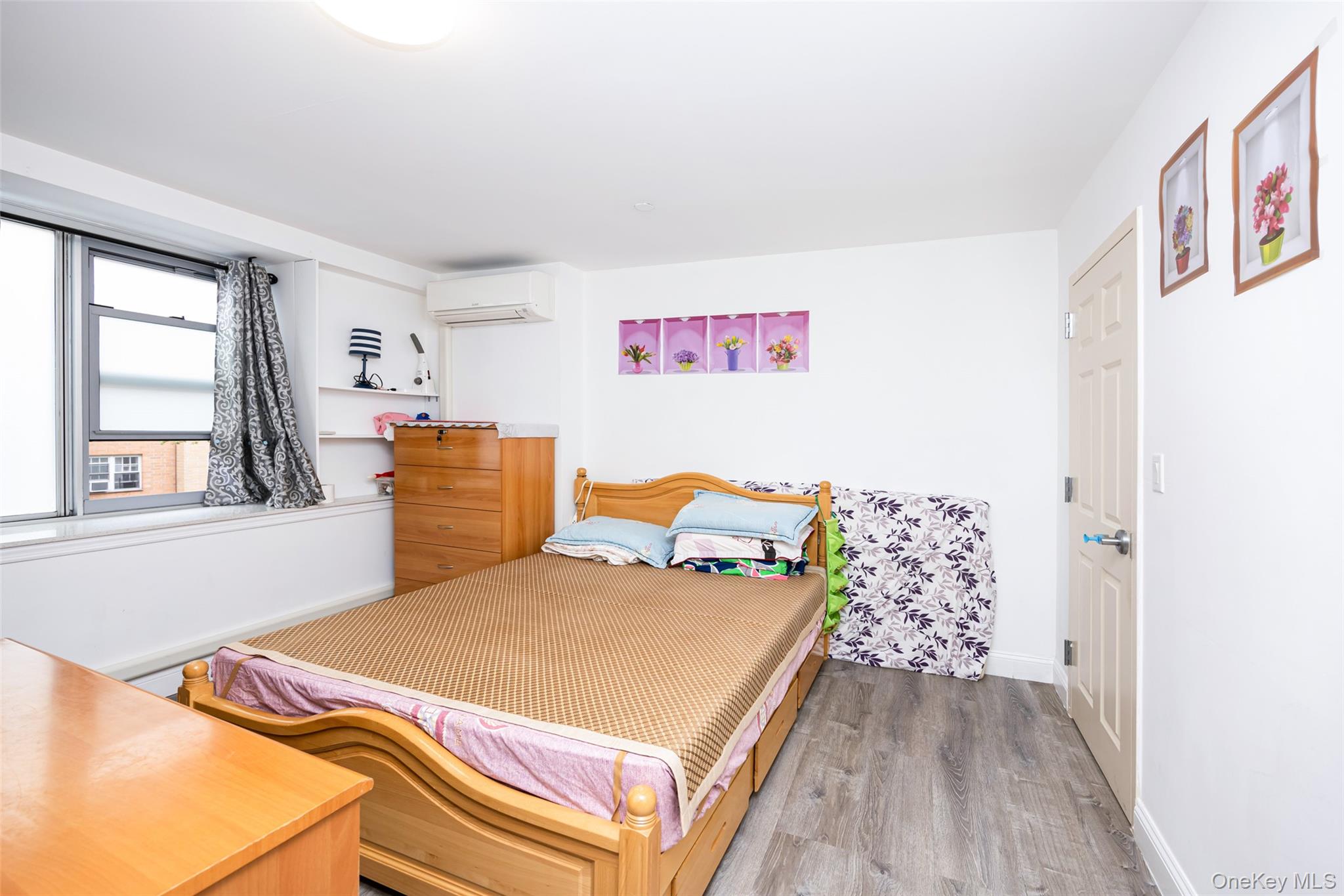 43-17 Union Street, Unit 4E Queens, NY 11355 - Photo 8 of 19 Bedroom featuring wood finished floors and a wall mounted AC