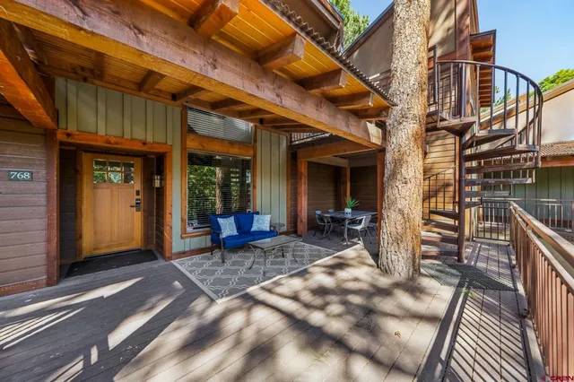 a view of a house with backyard porch and sitting area