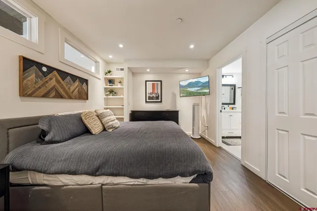 a living room with a bed furniture and a large mirror