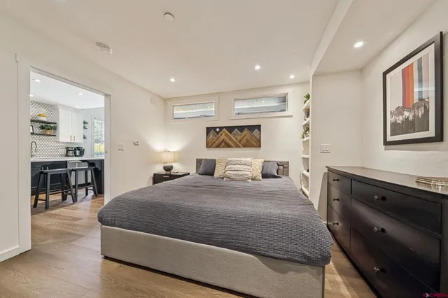 a spacious bedroom with a large bed and a dresser