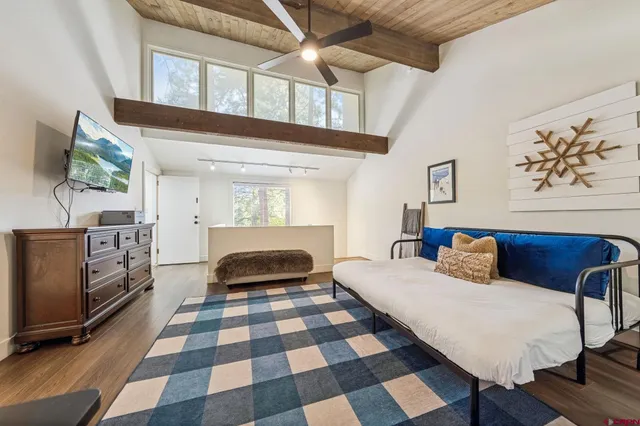 a bedroom with a bed and a mirror on the dresser