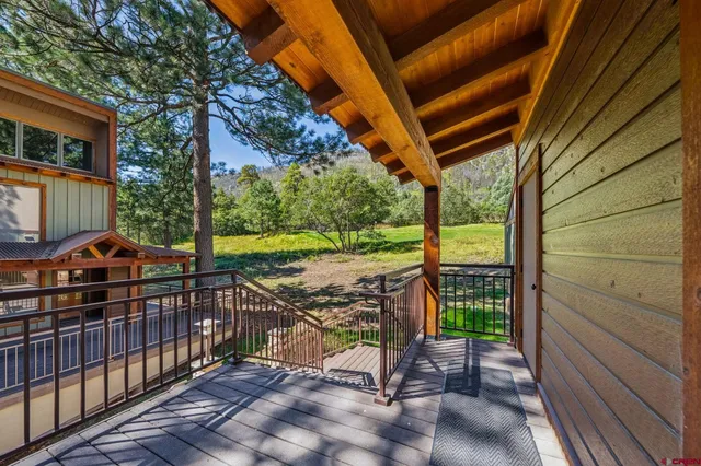 a view of a porch with wooden floor and fence
