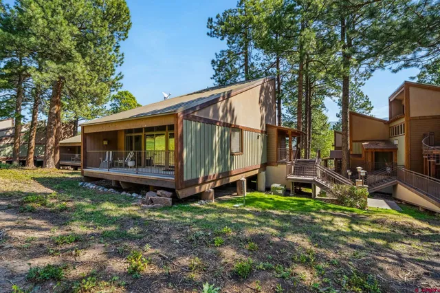 a view of a house with backyard and sitting area
