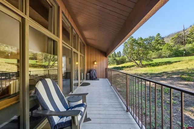 a view of balcony with furniture