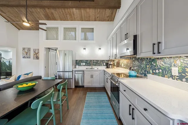 a kitchen with appliances cabinets and furniture
