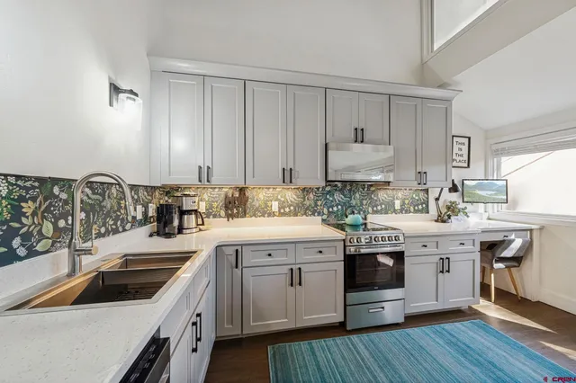 a kitchen with a white cabinets and sink