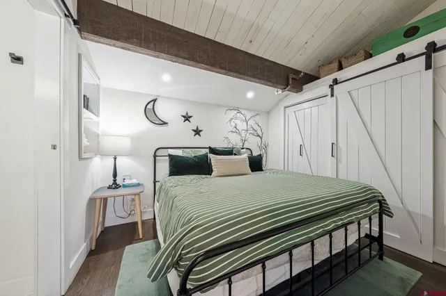 a bedroom with a bed and a night stand