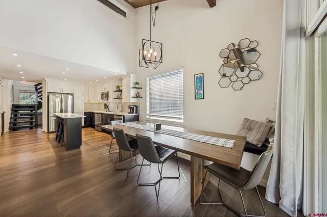 a view of a dining room with furniture wooden floor and a chandelier