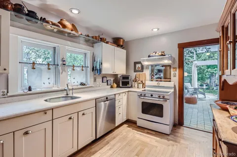 a kitchen with stainless steel appliances granite countertop a stove and a sink
