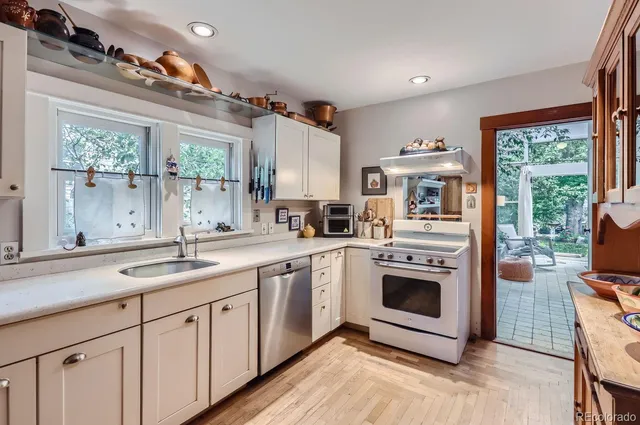 a kitchen with stainless steel appliances granite countertop a stove and a sink