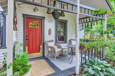 a front view of a house with outdoor seating and plants