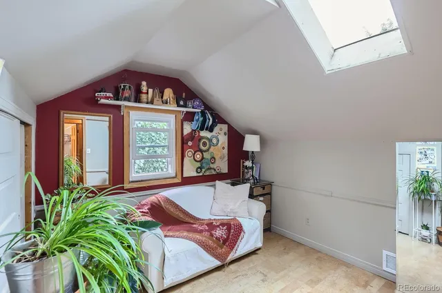 a bedroom with a bed and a book shelf