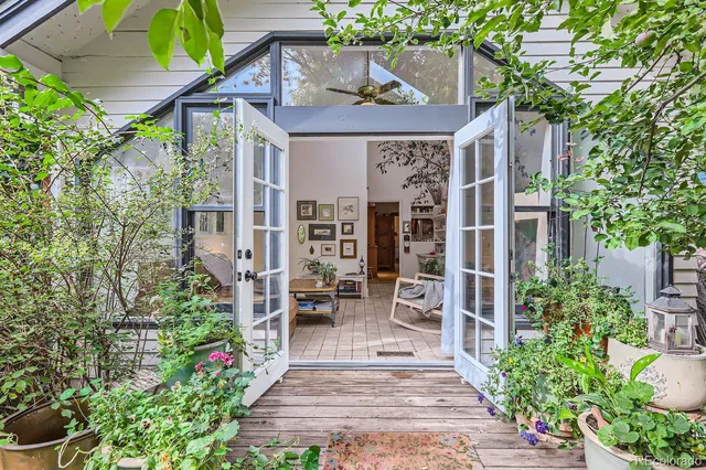 a view of a patio with chairs and potted plants
